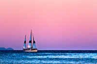 Sail boat on sea at sunset