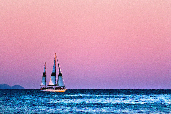 Sail boat on sea at sunset