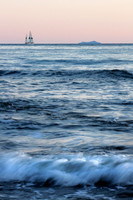 Ocean sunset with sailboat